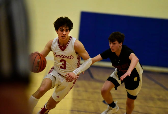 Cardinal Mooney's Trent Rice dribbles past a defender during a game earlier this season. The junior led all scorers with 24 points in the Cardinals' 76-52 win over Warren Michigan Math & Science on Friday.