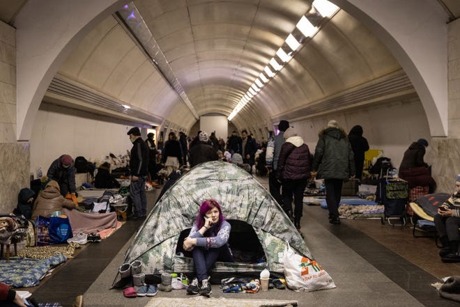 A woman sits in a tent as people take shelter in the Dorohozhychi subway station which has has been turned into a bomb shelter on March 02, 2022 in Kyiv.