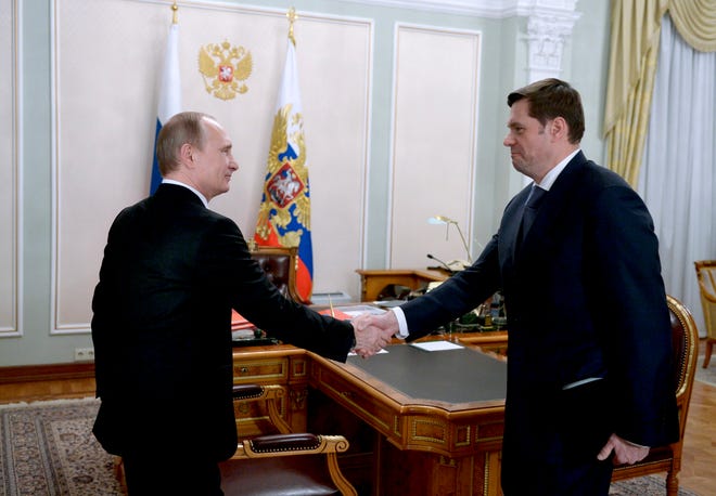 Russian President Vladimir Putin greets Severstal chief executive Alexei Mordashov in a meeting outside Moscow in January 2015.