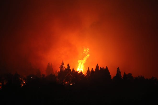 This file photograph taken on Dec. 29, 2021, shows a view of the flames of a forest fire in Paraje Villegas, Rio Negro province, south of Bariloche, Argentina. A new report released by the Intergovernmental Panel on Climate Change (IPCC) looks at the increasing impact of climate change.