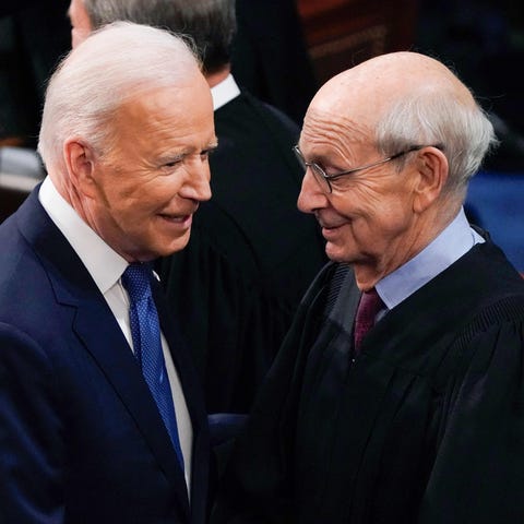 President Joe Biden greets Supreme Court Associate