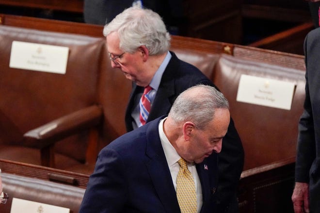 US Senate Majority Leader Chuck Schumer (front) and Senate Minority Leader Mitch McConnell (rear) arrive before President Joe Biden delivers his first State of the Union address to a joint session of Congress, at the Capitol in Washington, DC, on March 1, 2022.