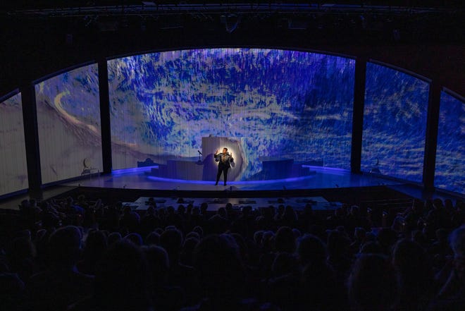 Jennifer Kidwell explains the ocean as she is surrounded by it in "Ocean Filibuster" at the American Repertory Theater in Cambridge and streaming later this month.