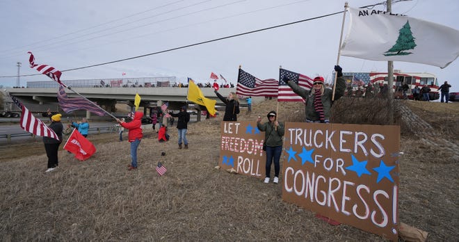 Supporters cheer as the People's Convoy passes by on Interstate 70 in West Jefferson on Thursday. About 150 gathered at the Rt. 142 bridge over the interstate, just a few miles west of Columbus, where another convoy is expected to pass through Sunday.