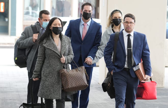 William Husel (center) holds the hand of his wife Mariah as they arrive for his 14-count murder trail Thursday, March 3, 2022 at Franklin County Common Pleas Court. At left is Husel's lead defense attorney, Jose Baez and in front of them are two unidentified members of his defense team. Husel is facing 14 counts of murder for allegedly hastening the deaths of patients in the Mt. Carmel hospital intensive care unit by prescribing excessive doses of painkillers. 