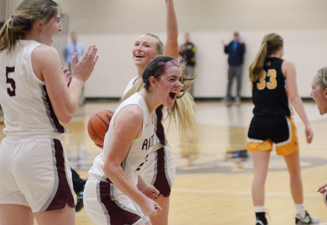 Charlevoix's Taylor Petrosky (front), Abbey Wright (left) and Camryn Turkelson (back) celebrate the win over Harbor Springs moments after the final horn rang Wednesday.