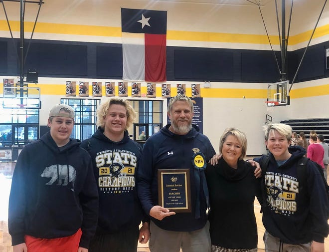 Coach Jeremiah Butchee, center, was recently recognized by his peers as Teacher of the Year at Stephenville High School. Here he is pictured with his family after receiving the award.