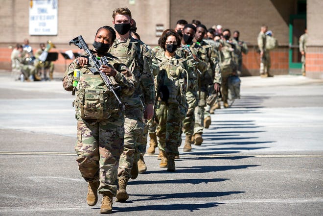 Some of the 180 soldiers with the U.S. Army 3rd Infantry Division, 1st Armored Brigade Combat Team march to a charter airplane at Hunter Army Airfield during their deployment to Germany, Wednesday March 2, 2022 in Savannah, Ga. The division is sending 3,800 troops as reinforcements for various NATO allies in Eastern Europe. (Stephen B. Morton /Atlanta Journal-Constitution via AP)