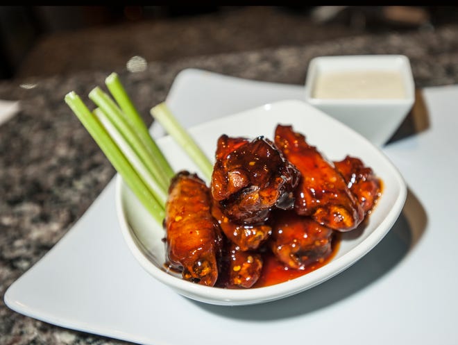 Smoked chicken wings with sweet chili sauce with celery and blue cheese.