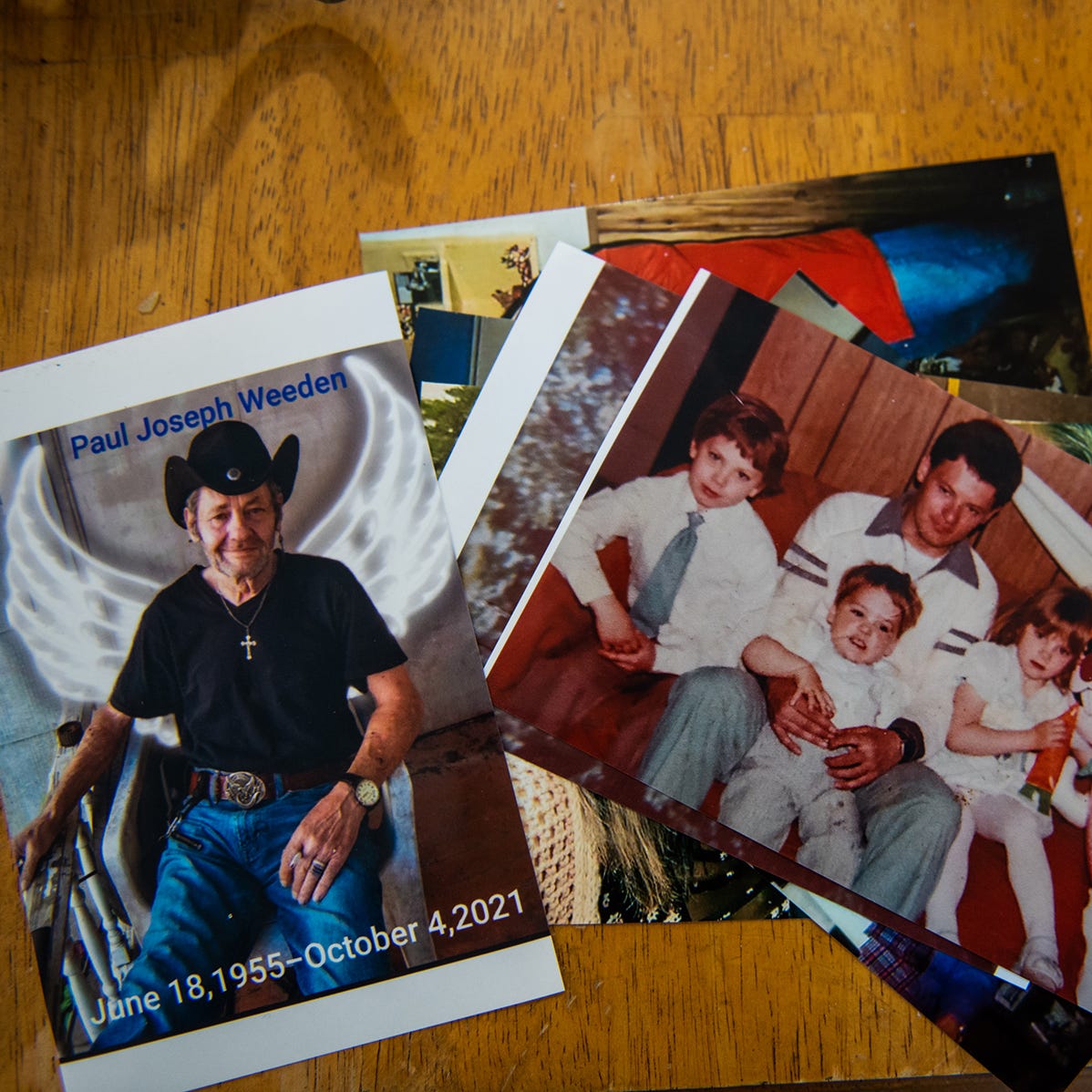 Photos of Paul Weeden Sr. lay on a table in Paul Weeden Jr's home in Livingston Manor, NY on Monday, March 28, 2022.