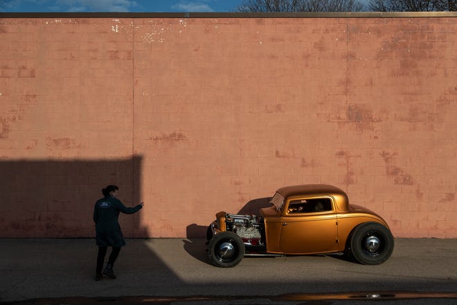 Autumn Riggle directs Logan Kucharek, who drives a 1932 Ford with flathead V8 engine, into a position for photo in Troy on March 1, 2022.