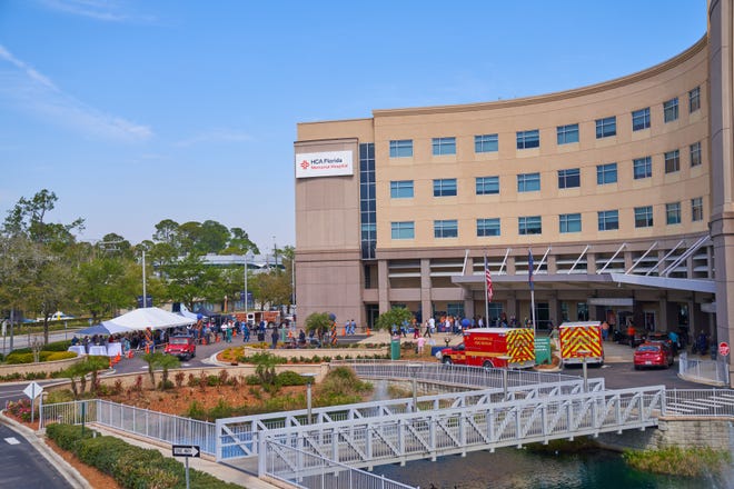 The new name for Memorial Hospital, which was founded in 1969, is unveiled on the side of the building Thursday. Orange Park Medical Center celebrated its new name, HCA Florida Orange Park Hospital, the same morning.