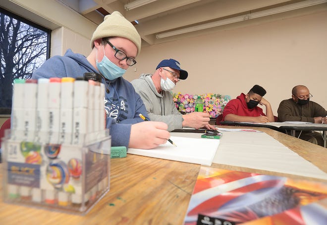 Brooke Mathias, 15, from left, her father Eric Mathias, Blake Pue, 15, and Frank Barnes work on their drawings and paintings in a recent art therapy class at the Canton Museum of Art.