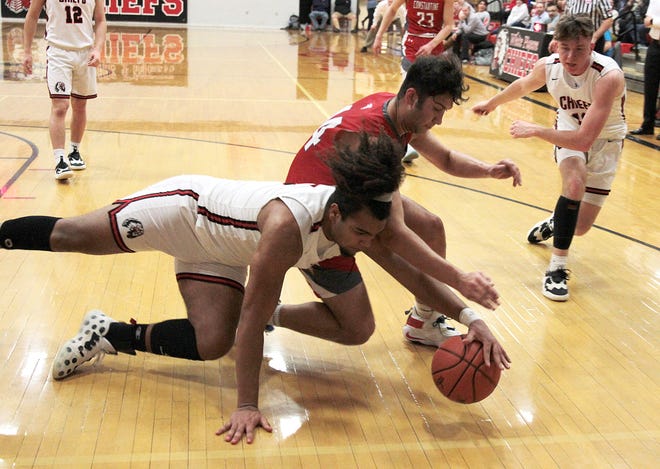 Chris Jackson of White Pigeon and Heston Wiggs of Constantine dive for a loose ball in prep hoops action on Thursday.