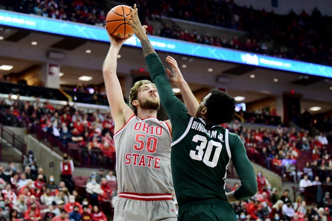 Joey Brunk of the Ohio State Buckeyes puts up a shot against Marcus Bingham Jr. of the Michigan State Spartans during the first half on Thursday, March 3, 2022, at Value City Arena in Columbus, Ohio.