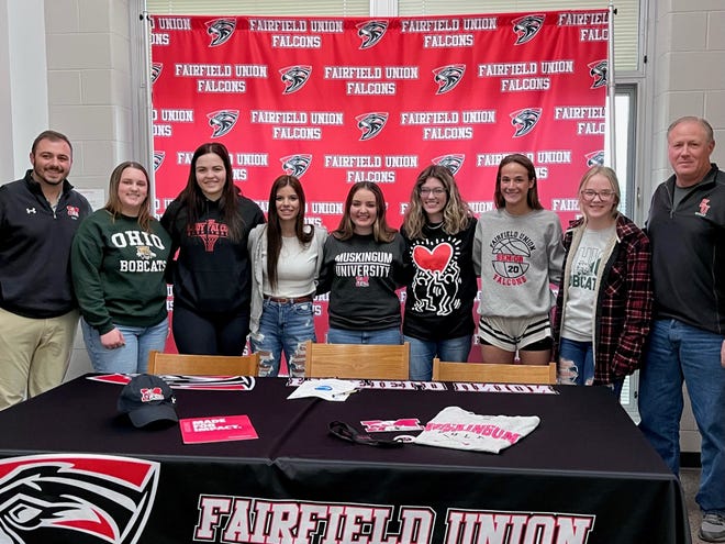 Fairfield Union senior Sydney Belville (center) stands with her golf teammates and coaches during he signing day to play golf at Muskingum University. Belville helped start the girls' golf program when she was a freshman.