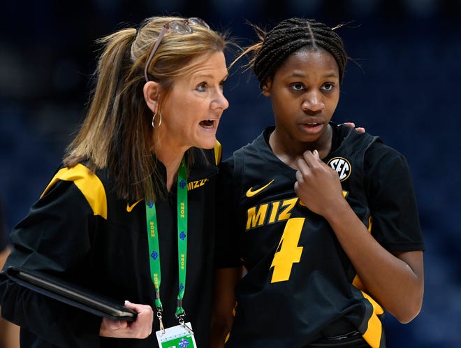 Missouri head coach Robin Pingeton talks with Mama Dembele (4) during the first half of an NCAA college basketball game against Arkansas at the women's Southeastern Conference tournament, Thursday, March 3, 2022, in Nashville, Tenn.