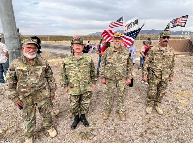 Members of the New Mexico Civil Guard attended a rally to greet a convoy of truckers at an Interstate 10 overpass near Mesquite, NM on Thursday, March 3, 2022.