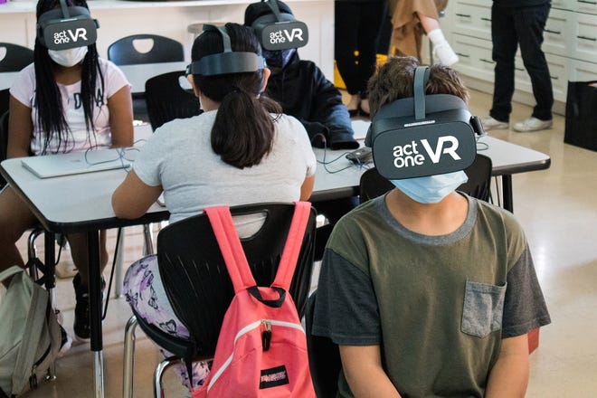 Students use virtual reality headsets to access arts education.