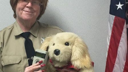 Pat McCoy-Coleman holding a teddy bear in a 2016 Clarkstown Police Department photo.