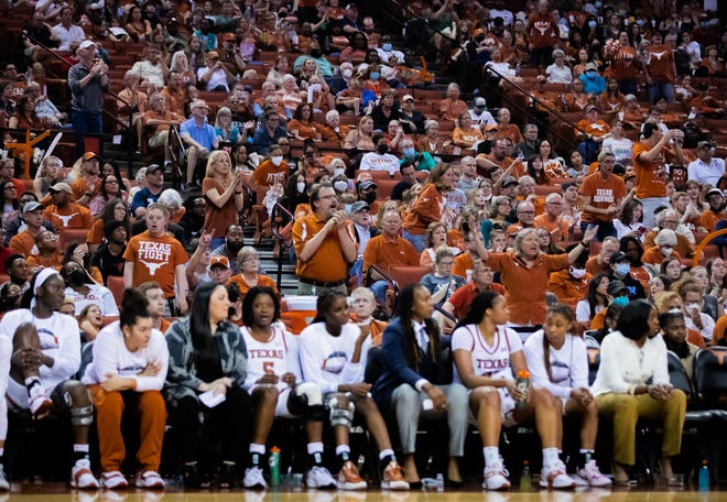 Fans behind the Texas bench rise to their feet during Texas' 65-50 win over Oklahoma State on Saturday at the Erwin Center. There were more than 12,000 fans at the game, which served both as the regular-season finale and the final regular-season game in Erwin Center history.