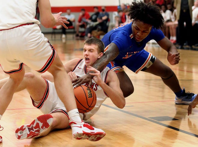 Glenwood High School's Josh Jones, center, fights for a loose ball with East St Louis' Macaleab Rich during the game Friday March 4, 2022. [Thomas J. Turney/The State Journal-Register]