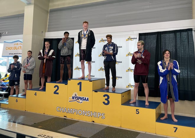 Corning senior Ryan McNutt is saluted following his N.Y. state 100-yard freestyle championship Saturday at Ithaca College.