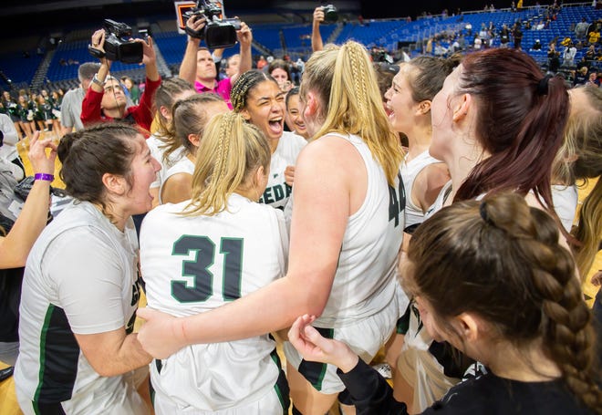 Cedar Park guard and state championship game MVP Gisella Maul, center, shouts in joy with her team after Cedar Park's 45-40 win in double overtime of the Class 5A girls UIL state championship Saturday at the Alamodome in San Antonio.
