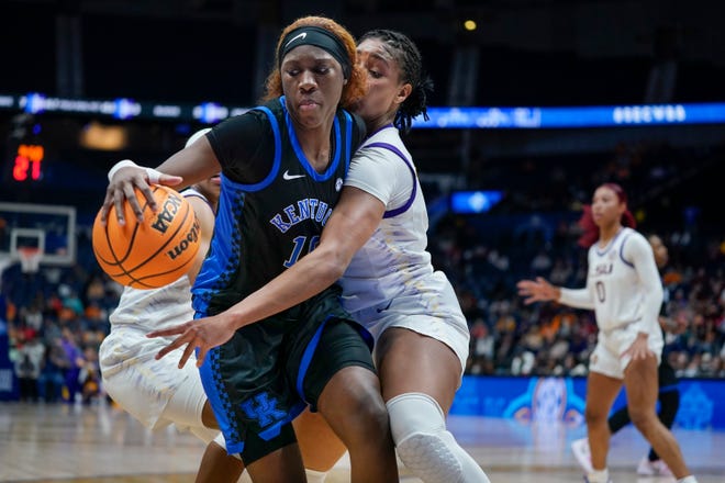 Kentucky's Rhyne Howard (10) and LSU's Awa Trasi battle for the ball in the second half of an NCAA college basketball game at the women's Southeastern Conference tournament Friday, March 4, 2022, in Nashville, Tenn. (AP Photo/Mark Humphrey)