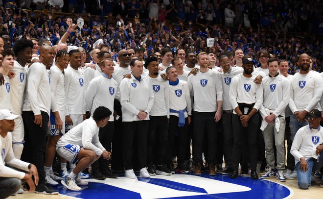 Duke Blue Devils head coach Mike Krzyzewski poses for a photo with his former and current players before his final home game at Cameron Indoor Stadium.