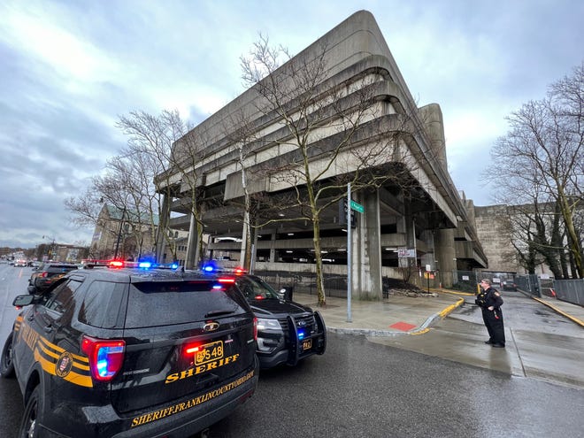 Franklin County Sheriff’s deputies secure the exterior of the county parking garage at 34 E. Fulton St. near South High Street on Monday morning following an altercation and shooting inside the garage on the seventh floor.