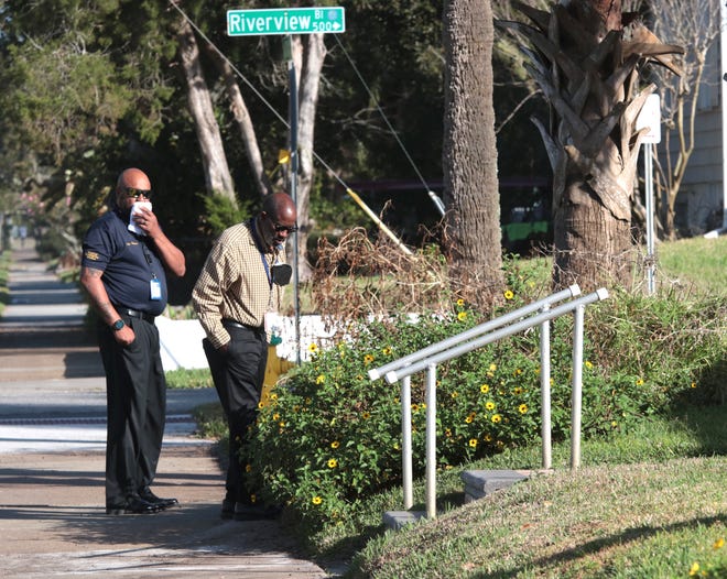 Daytona Beach Police detectives canvass the neighborhood along Wild Olive Avenue early Monday. According to authorities, a husband and wife riding their bicycles home from Main Street were brutally stabbed to death early Sunday morning.