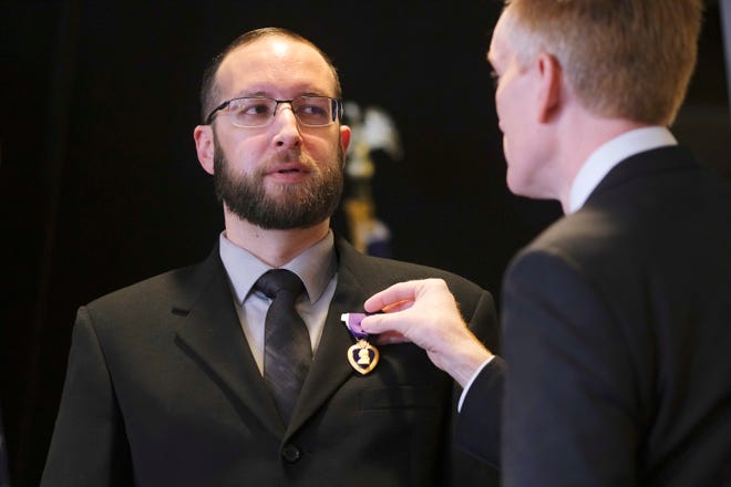 Carl Fastiggi is presented the Purple Heart on Monday by U.S. Sen. James Lankford at a ceremony at Kamp's Cafe in Oklahoma City.