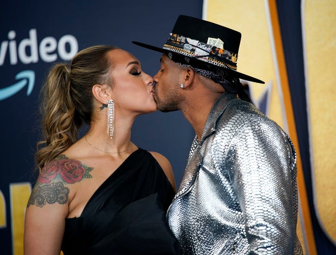 Jimmie Allen and Alexis Gayle arrive for the 57th Academy of Country Music Awards at Allegiant Stadium in Las Vegas, Nev., Monday, March 7, 2022.