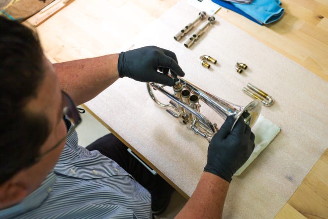El conservador del Museo de Instrumentos Musicales, Rodrigo Correa-Salas, vuelve a ensamblar una trompeta de latón plateada después de limpiarla y pulirla en el Laboratorio de Conservación MIM el 7 de marzo de 2022 en Phoenix, Arizona.
