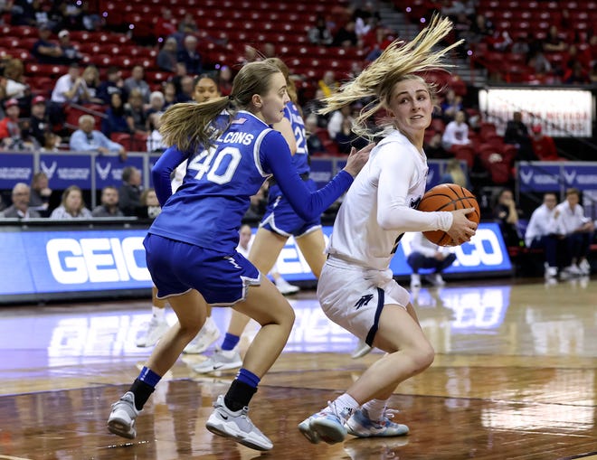 Wolf Pack guard Kenna Holt, right, looks to shoot around Air Force guard Jo Huntimer during the first half of the teams' Mountain West tournament game Monday