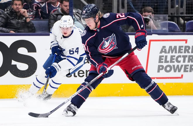 Columbus Blue Jackets left wing Patrik Laine (29) skates around Toronto Maple Leafs center David Kampf (64) during the first period of the NHL hockey game at Nationwide Arena in Columbus on March 7, 2022. 