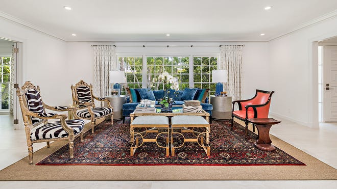 A large window is a focal point of the living room at 224 Via Marila, a North End house listed for sale at $14.95 million, with the furnishings available separately.