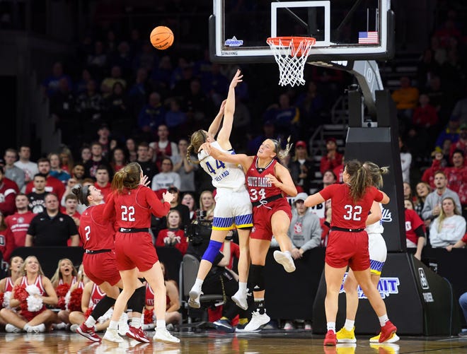 South Dakota's Myah Selland and South Dakota's Hannah Sjerven collide under the basket in the Summit League championship game Tuesday, March 8, 2022 at the Denny Sanford Premier Center in Sioux Falls.