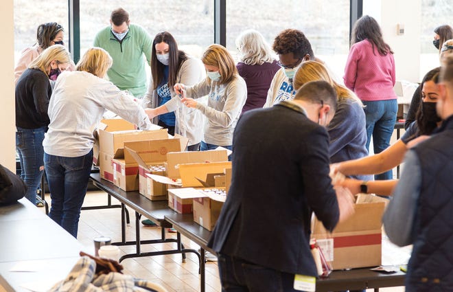 Bath and Body Works employees volunteer with BESA to assemble care packages.