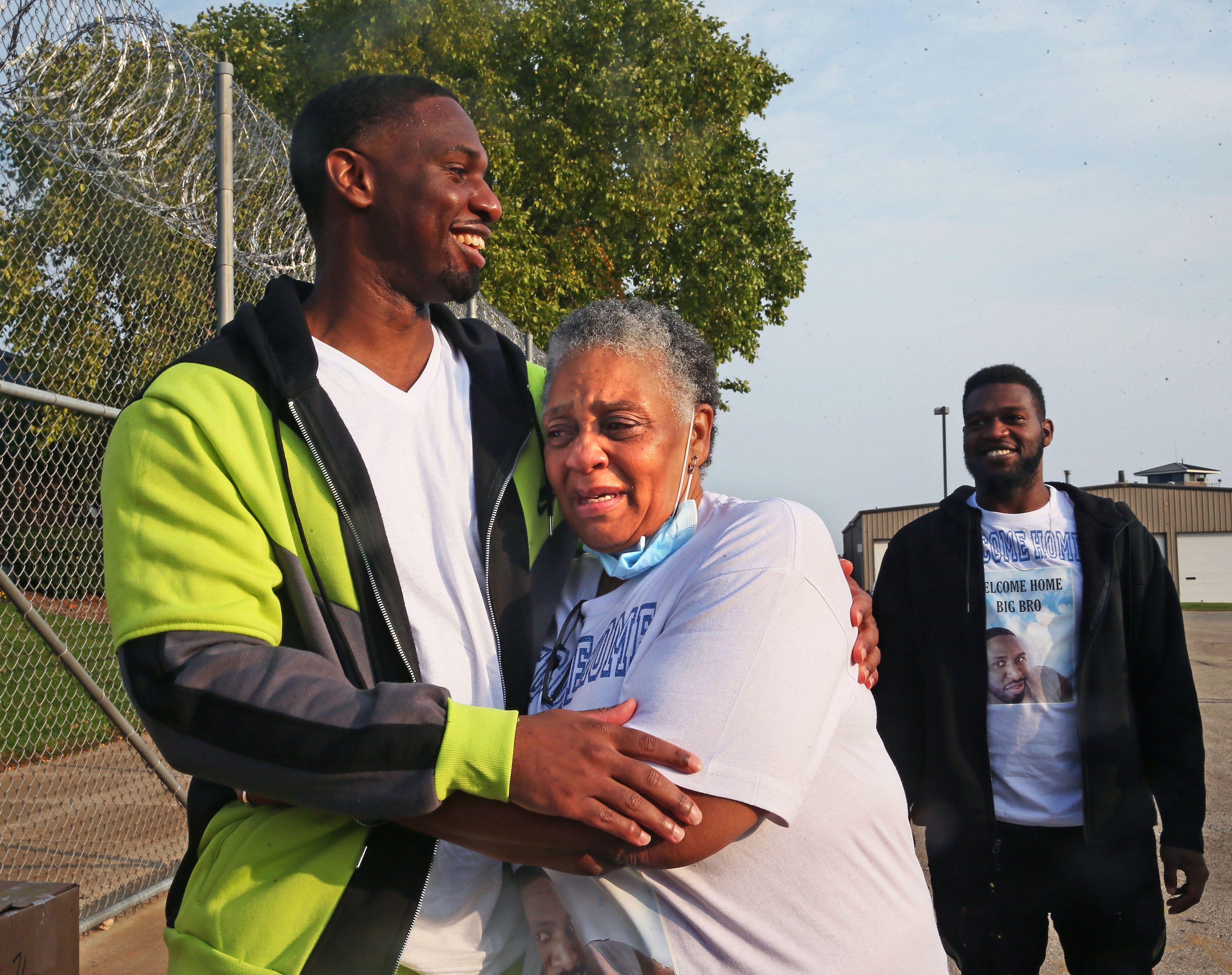 Doris Williams, 65, center, is overcome with emotion when her son Marlin Dixon, left, is released from the John C. Burke Correctional Center while his brother Alex Dixon watches.