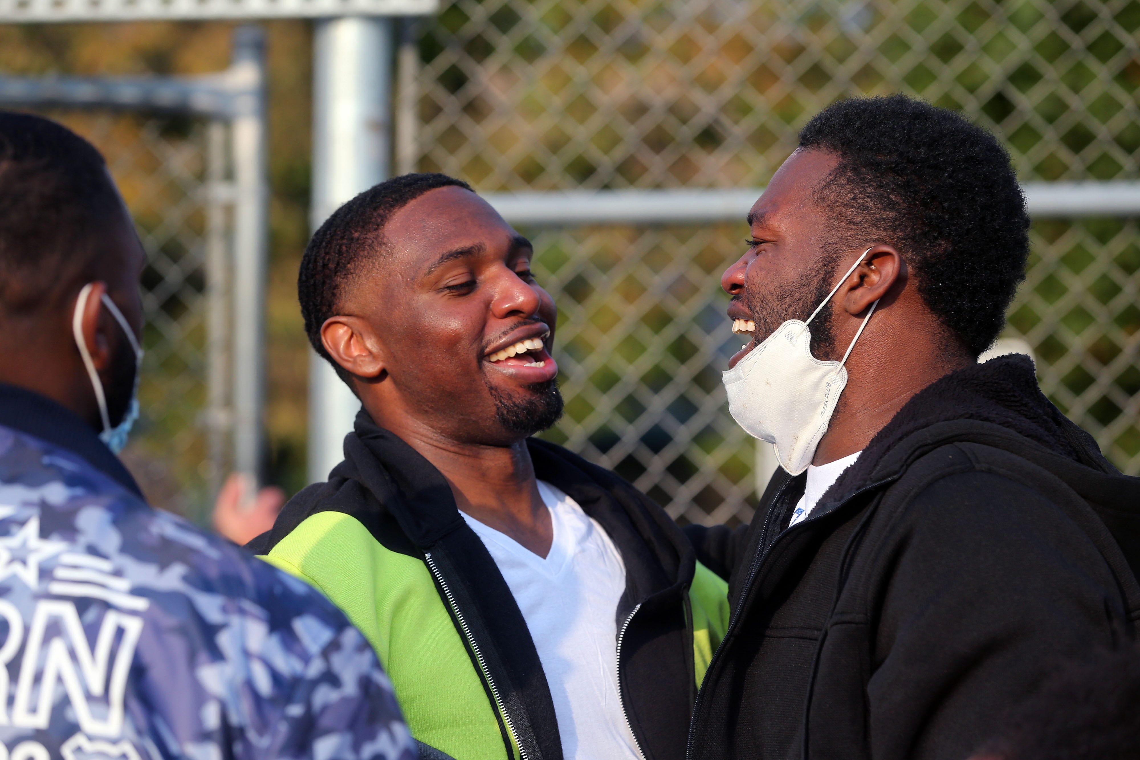 Marlin Dixon, center, talks with his brothers, Darryl Dixon, left, 28, and Alex Dixon, right, 30, after being released from the John C. Burke Correctional Center.