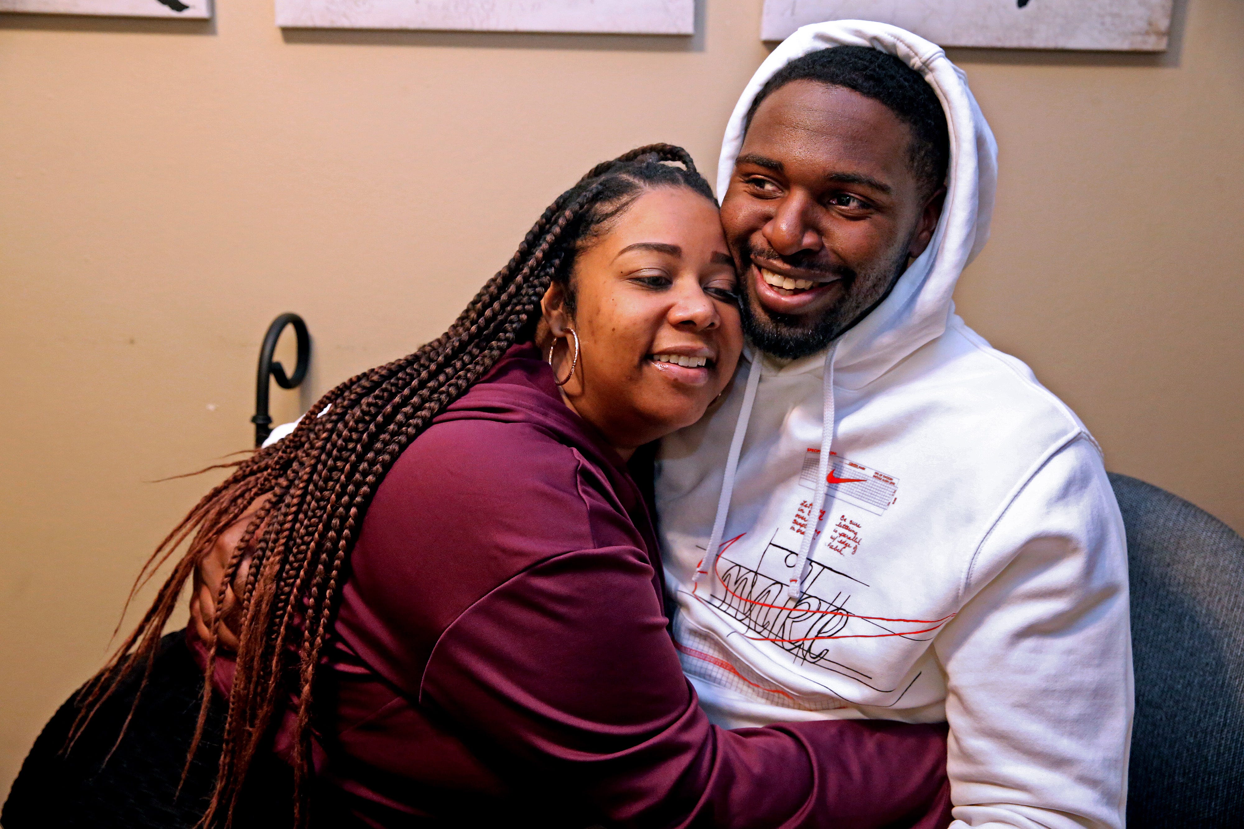 Tyanna Cates, left, Marlin Dixon's girlfriend, hugs him at his apartment in Menomonee Falls. The two met the second day of his release from John C. Burke Correctional Center.