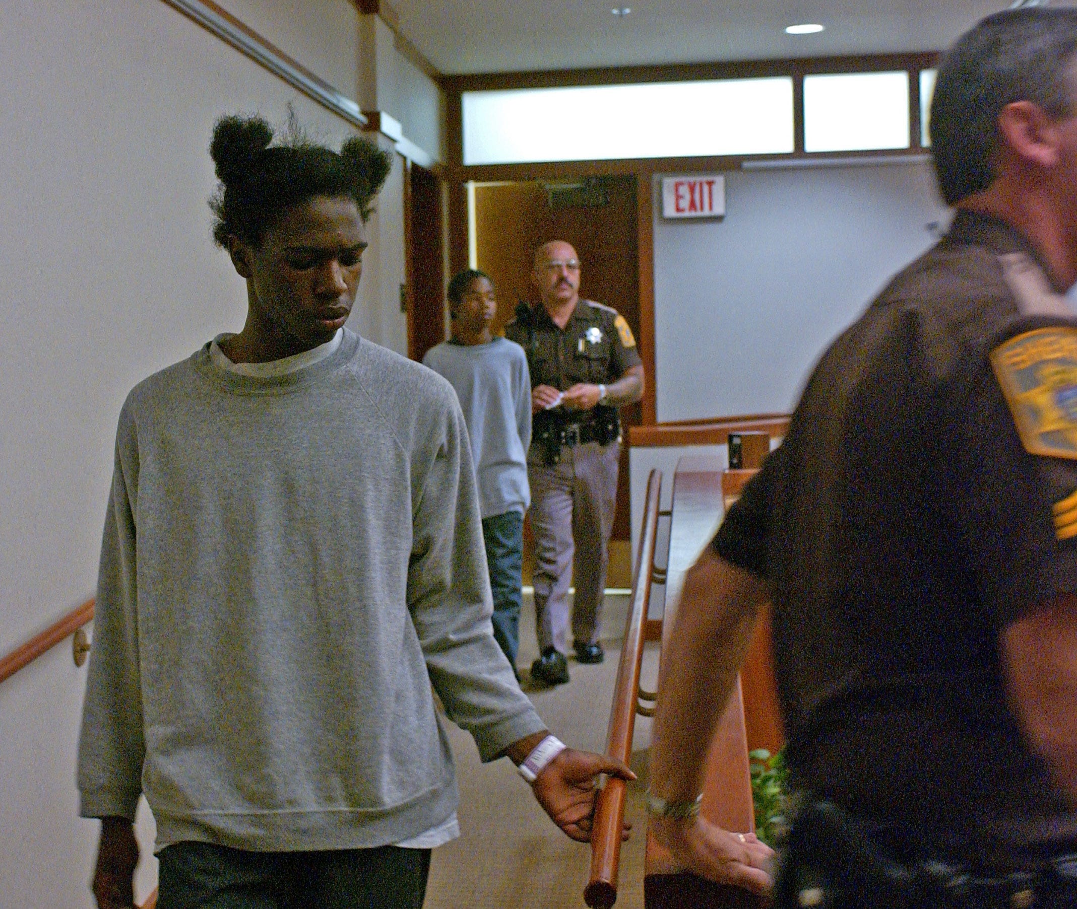 Marlin Dixon is led into Milwaukee County Children's Court by a sheriff's deputy on Oct. 3, 2002, where he was charged as an adult in the murder of Charlie Young Jr.