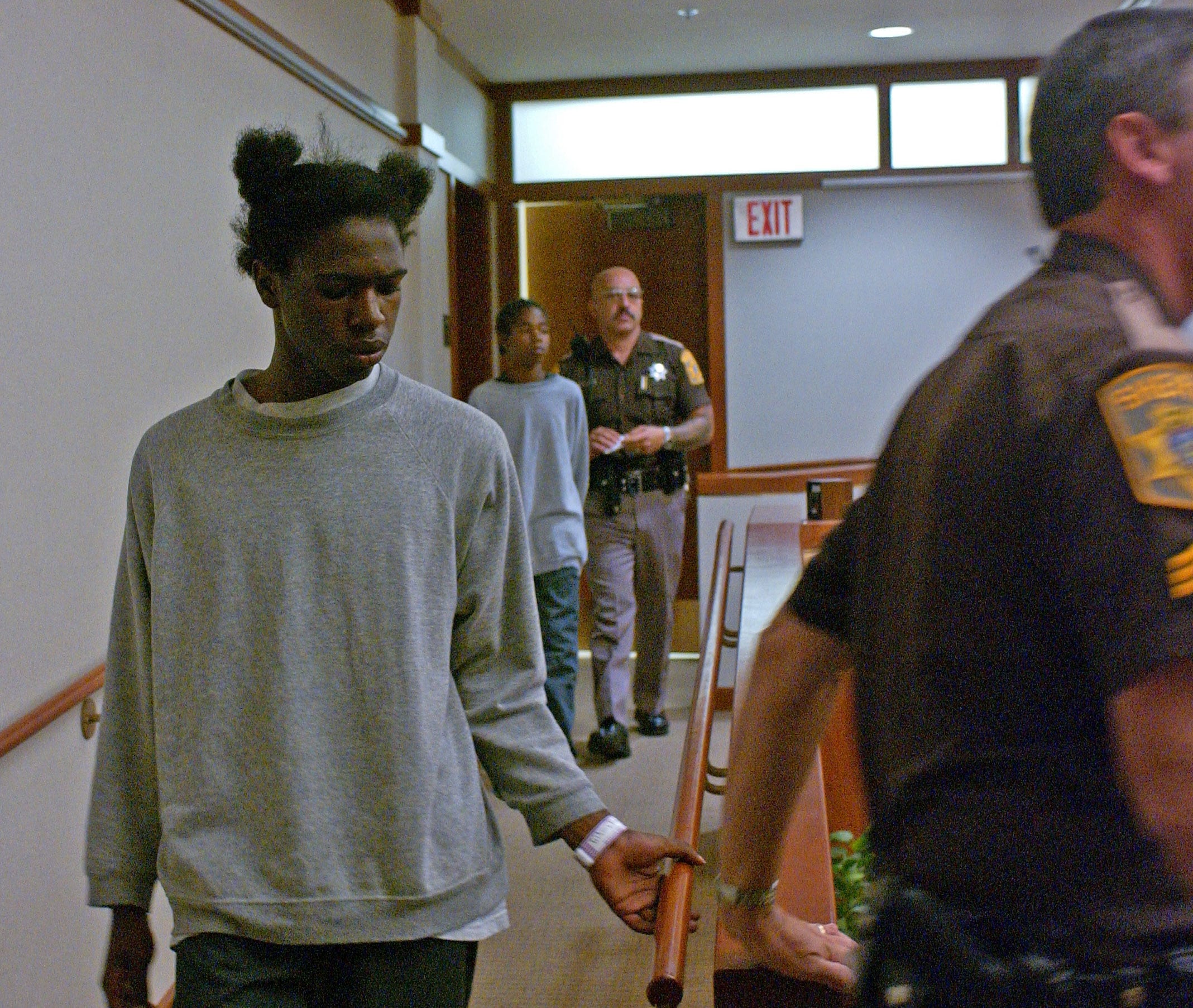 Marlin Dixon is led into Children's Court by a Sheriff's deputy, charged as an adult in the 2002 killing of Charlie Young, Jr. He ultimately received that harshest sentence of all those involved in the mob beating. He was 14 years old when arrested, 15 when sentenced.