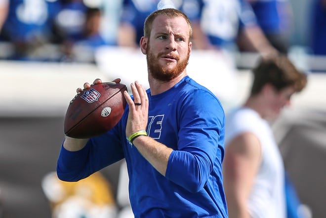 FILE - Indianapolis Colts quarterback Carson Wentz (2) throws a pass during warm-ups before of an NFL football game against the Jacksonville Jaguars, Sunday, Jan. 9, 2022, in Jacksonville, Fla. The Washington Commanders have agreed to acquire quarterback Carson Wentz from the Indianapolis Colts, according to a person with direct knowledge of the situation. The person spoke to The Associated Press on condition of anonymity Wednesday, March 9, 2022, because the deal cannot be finalized until the start of the new league year next week. (AP Photo/Gary McCullough, File)