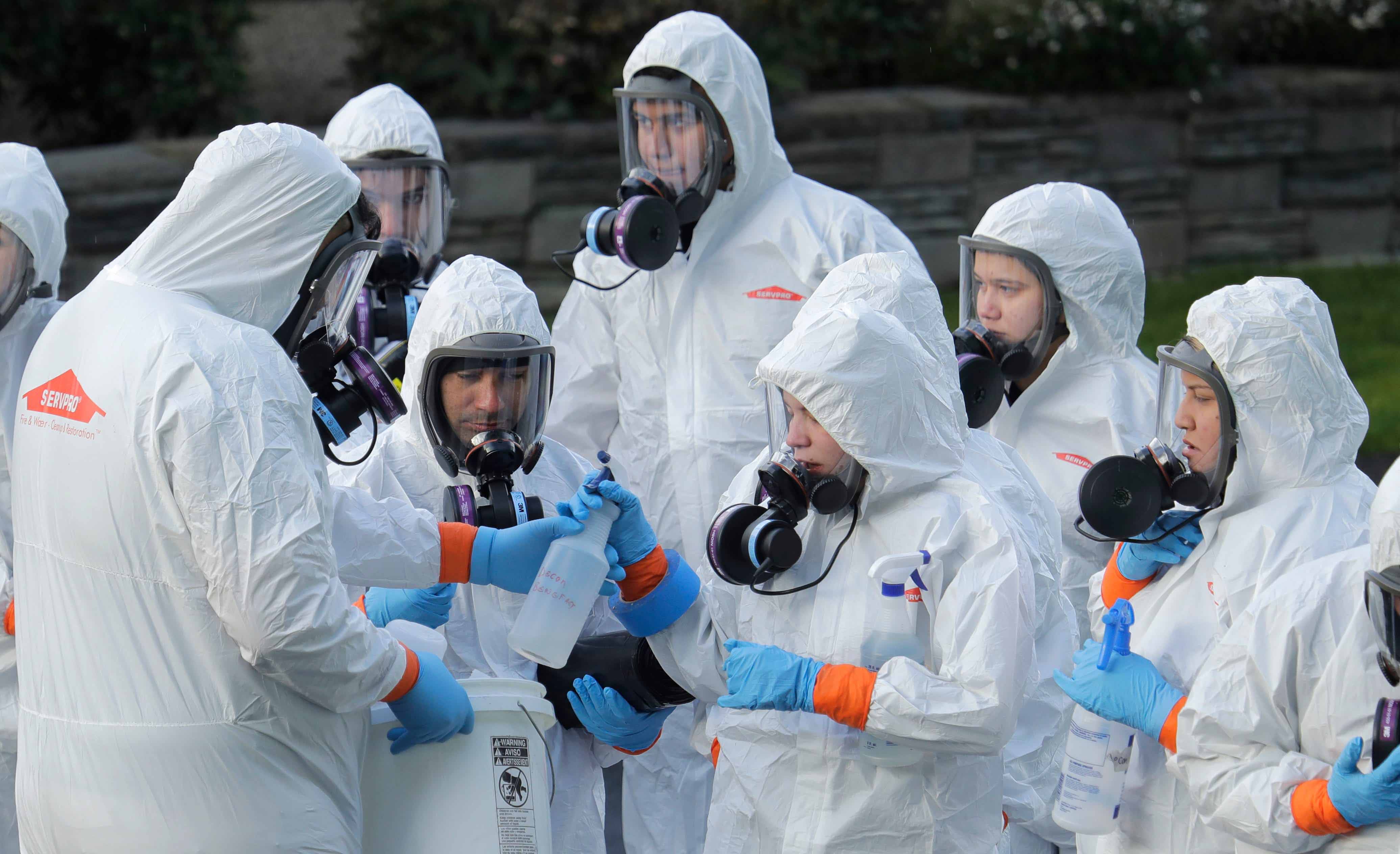 Disaster recovery workers wore protective gear to enter the Life Care Center in Kirkland, Washington in March 2020 during the first major outbreak of COVID-19 in a U.S. nursing home.