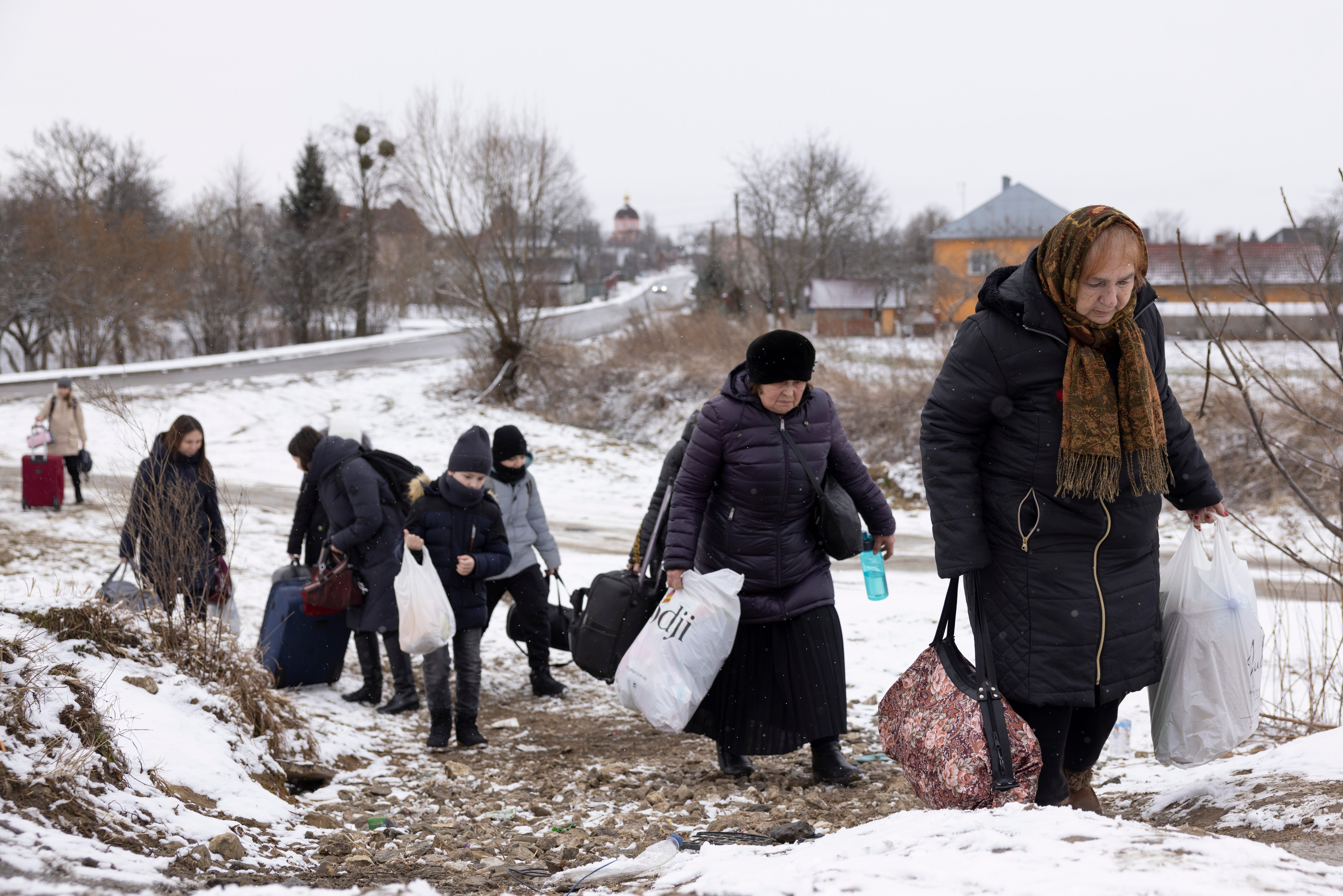 Refugees fleeing conflict make their way to the Krakovets border crossing with Poland on March 9, 2022 in Krakovets, Ukraine.