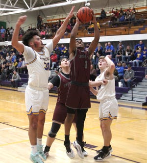 Union City senior Terrance Morgan Jr. goes up strong after pulling down an offensive rebound versus Centreville Wednesday night. Uc's Phoenix Elkins looks on