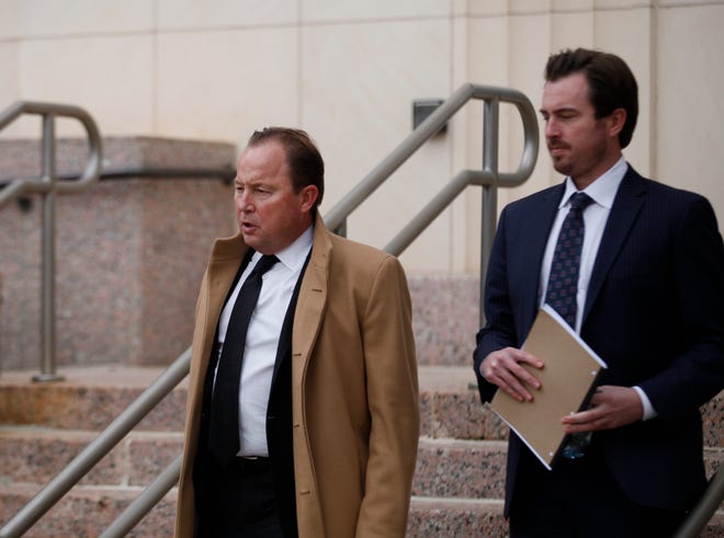 Bart Reagor, left, walks out of the federal courthouse in Amarillo with his son, Ryan, after he was sentenced to 14 years in prison for lying to a bank to obtained a $10 million loan for his business. He spoke briefly to reporters outside maintaining his innocence, saying he plans on appealing his conviction.